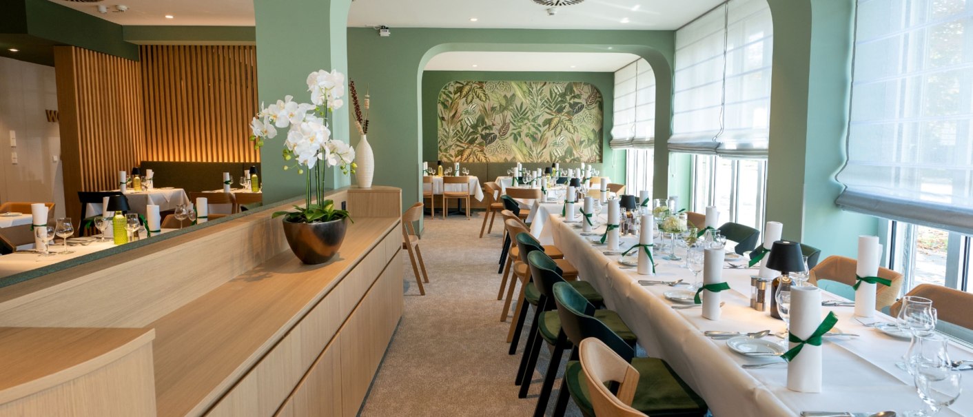 Elegant breakfast room with green walls, laid tables and orchids. Large windows let in plenty of light., © Erikson Hotel