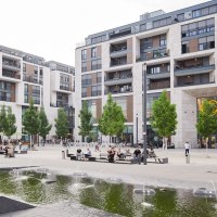 The Milaneo shopping center on Mailänder Platz with modern buildings, trees and a fountain in the foreground. People sit and walk., © Peter Oppenländer The Milaneo shopping center on Mailänder Platz with modern buildings, trees and a fountain in the foreground. People sit and walk., © Peter Oppenländer