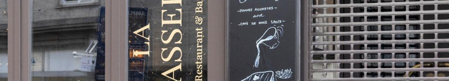 Entrance of 'La Brasserie' with menu board offering entrec&ocirc;te de Charolais with fries and Caf&eacute; de Paris sauce., &copy; SMG, Sarah Schmid