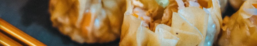 Close-up of steamed dumplings with chopsticks on a plate. The dumplings are filled and have a light, shiny surface., &copy; C&auml;ff Chen, Stuttgart