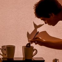 Person stirs in a cup, projects shadows onto a screen. Creative play with light and shadow., &copy; FITZ! Stuttgart