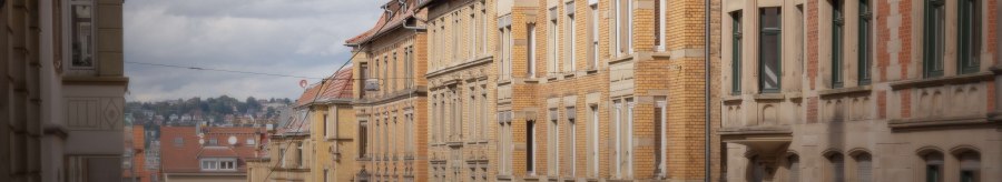 Row of historic buildings with brick facades under a cloudy sky. Other buildings can be seen in the background., &copy; Stuttgart Marketing GmbH, Martina Denker