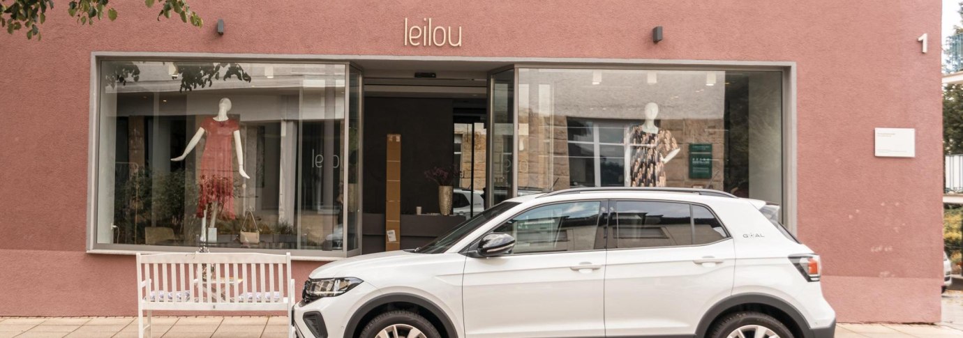 Ein Modegeschäft namens "leilou" mit Schaufensterpuppen. Ein weißes Auto parkt davor. Die Fassade ist rosa., © Stuttgart Marketing GmbH, Sarah Schmid