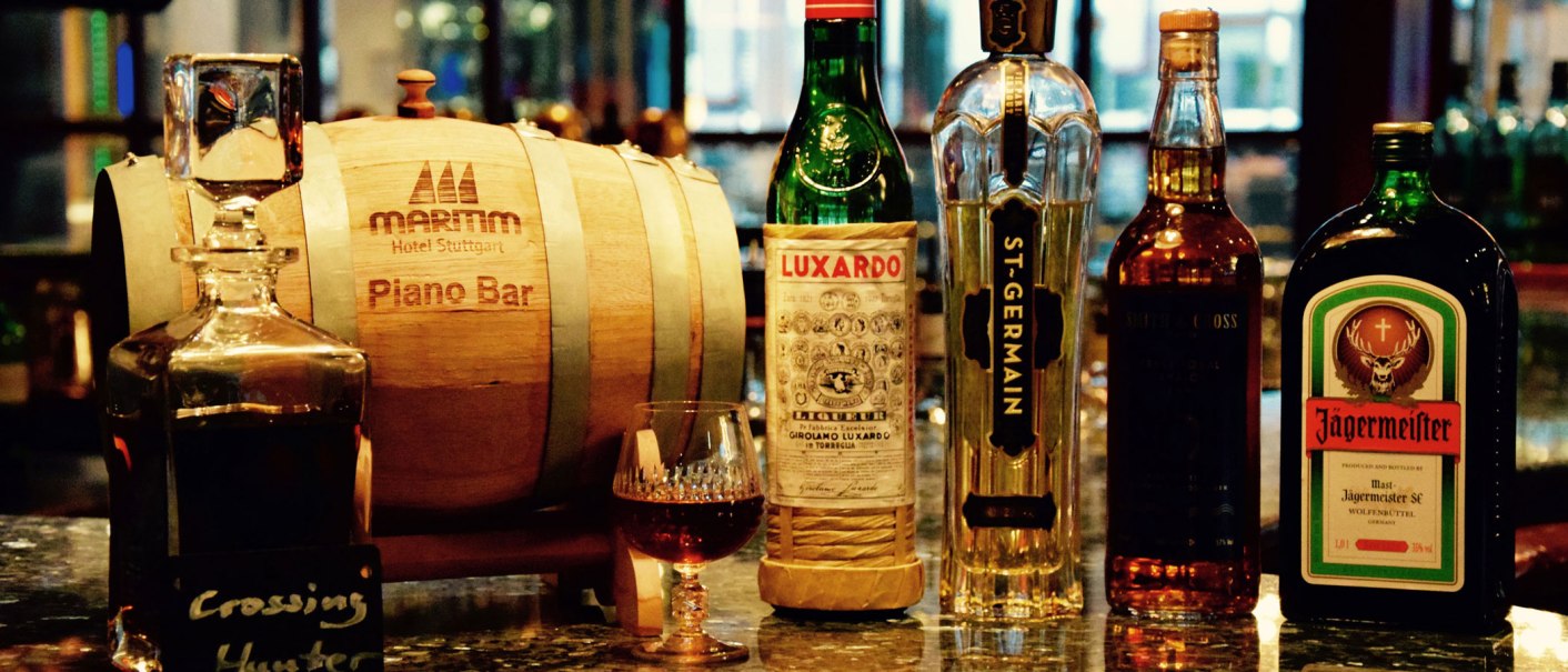 A bar with bottles of spirits such as Luxardo, St-Germain and J&auml;germeister next to a wooden barrel from the Maritim Hotel Stuttgart Piano Bar., &copy; Maritim Hotels