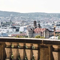 View of Stuttgart from Eugensplatz, with historic buildings and green hills in the background. A railing in the foreground., &copy; Stuttgart-Marketing GmbH Romeo Felsenreich, sommertage.com