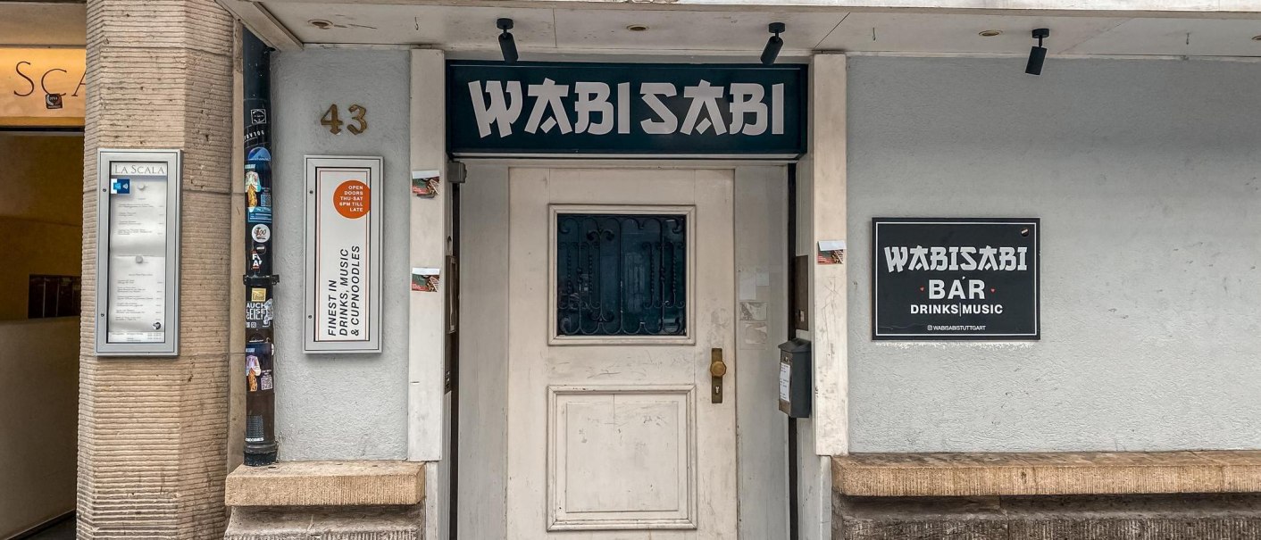 Exterior view of the Wabisabi Bar, showing the entrance door, signs, and the house number 43. The bar offers drinks, music, and Cup Noodles., © SMG Stuttgart Marketing GmbH - Thabea Zauder Exterior view of the Wabisabi Bar, showing the entrance door, signs, and the house number 43. The bar offers drinks, music, and Cup Noodles., © SMG Stuttgart Marketing GmbH - Thabea Zauder