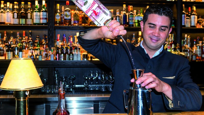A bartender pours gin into a jigger. Numerous bottles can be seen on a shelf in the background., &copy; &copy; TMBW, Gregor Lengler
