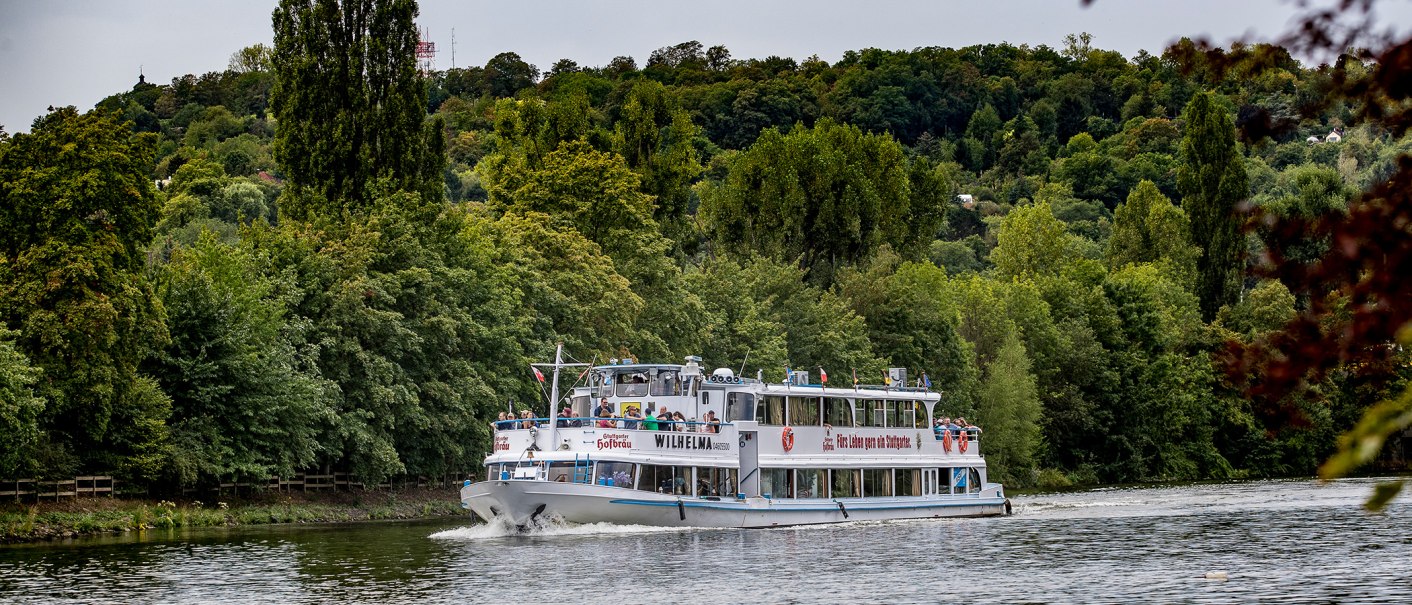 The Wilhelma excursion boat sails along a river surrounded by dense forest and green hills., © all copyrights are reserved by maks richter The Wilhelma excursion boat sails along a river surrounded by dense forest and green hills., © all copyrights are reserved by maks richter