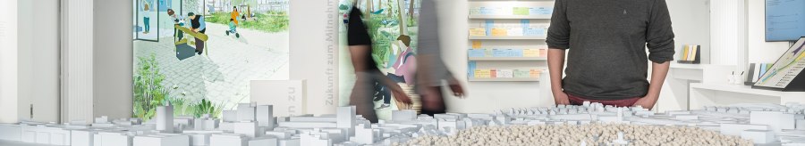 A man looks at an architectural model in an exhibition. Illustrations and notes can be seen on the wall in the background., &copy; Dominique Brewing
