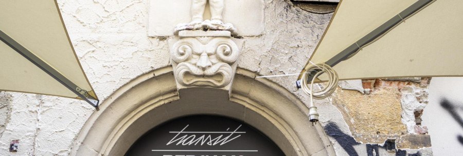 Stone figure above an archway with the inscription 'transit BERGAMO'. Graffiti and weathered wall in the background., &copy; SMG, Sarah Schmid