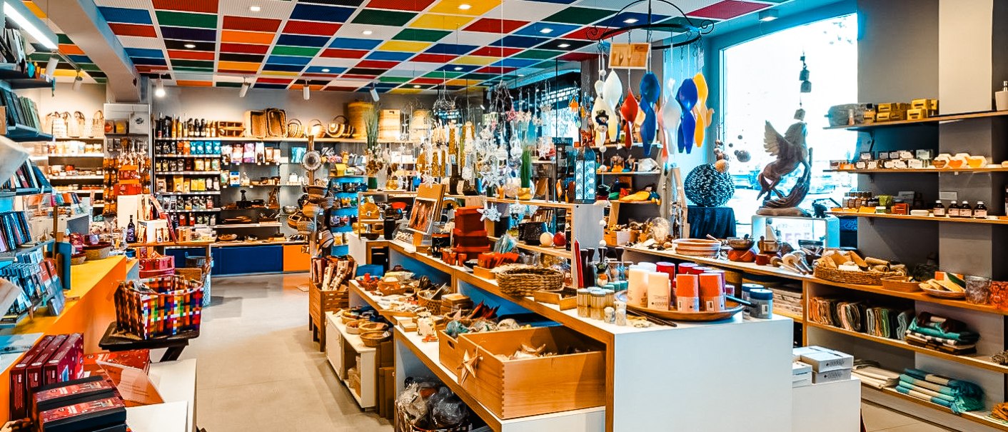 Colorful world store with a variety of products and a colorful ceiling. Shelves are full of goods, including candles, handicrafts and food., &copy; Michael Sommer