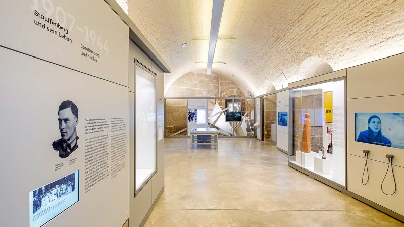 Interior view of the Stauffenberg memorial with modern exhibits, information boards and screens in a vaulted room., &copy; Daniel Stauch Photography