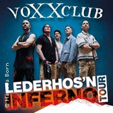 Die Band voXXclub posiert in traditioneller Kleidung f&uuml;r die Lederhos'n Inferno Tour. Der Hintergrund ist blau mit dem Tourtitel in gro&szlig;en Buchstaben., &copy; links im Bild